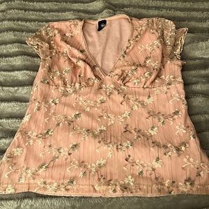 Medium size. Floral printed pink top. Thread work on the top. Mesh sleeves.